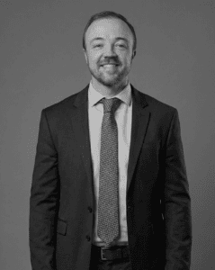 Professional man in suit smiling for business portrait.